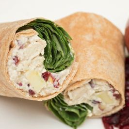 A close up of a chicken salad wrap on a plate
