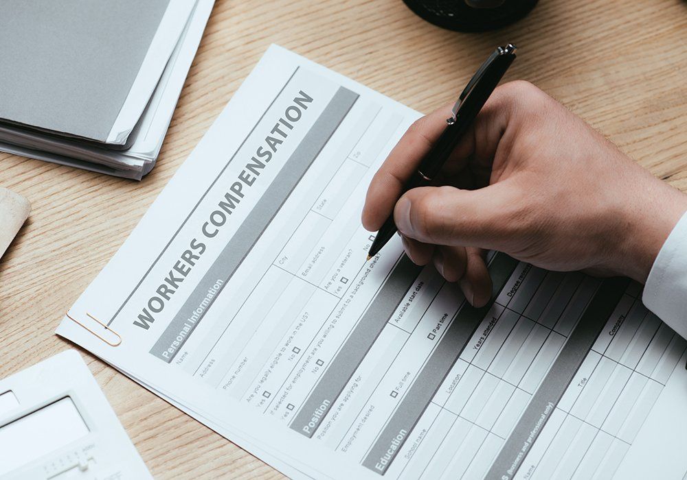 Man Filling in Workers Compensation Form — Weston, FL — All Lines Insurance Inc. Man Filling in Workers Compensation Form — Weston, FL — All Lines Insurance Inc.