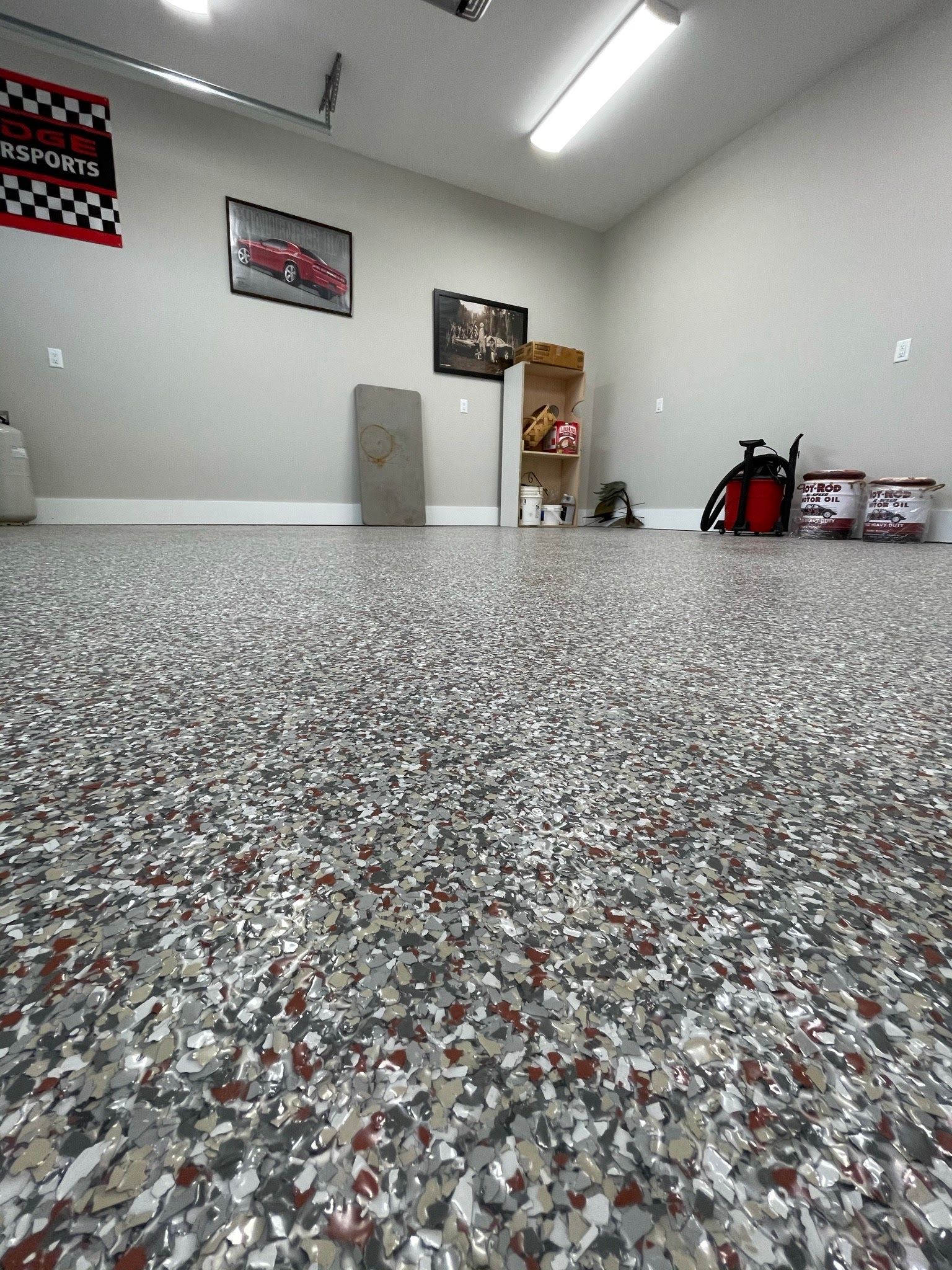 A garage with a gray and red colored floor.