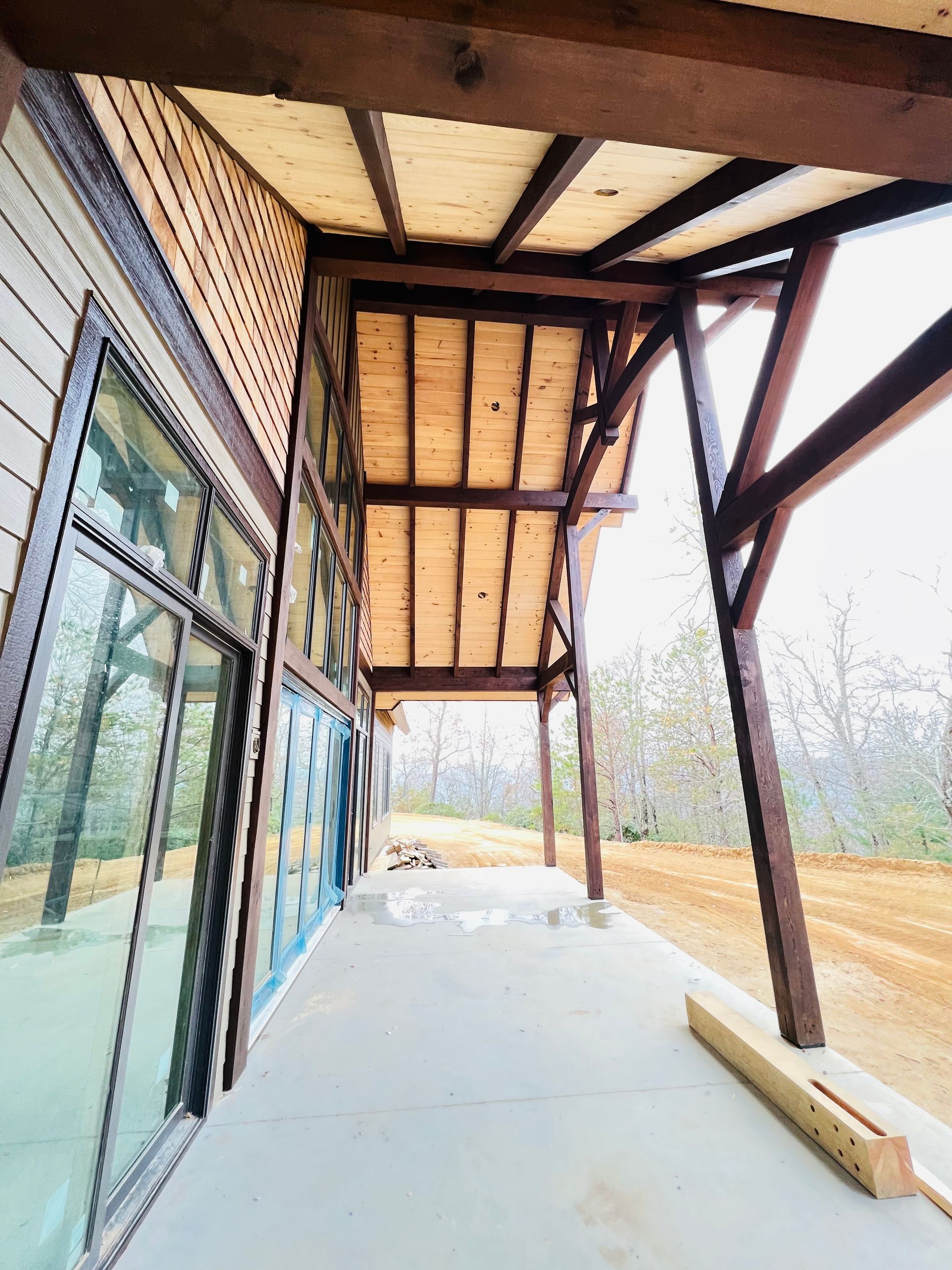 A porch with a wooden roof and a lot of windows