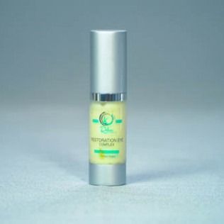 Small, silver bottle of eye cream with yellow liquid.