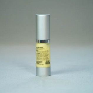 Silver and yellow cosmetic bottle on a light gray background.