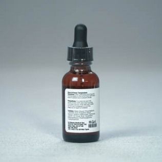 A brown glass bottle with a black dropper cap, white label, against a gray background.