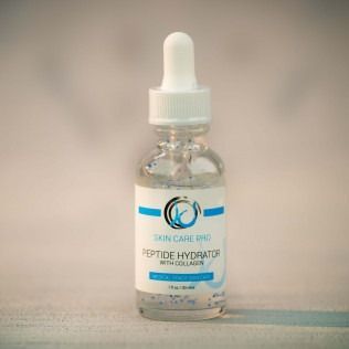 A clear glass bottle of Skin In Care Pro Peptide Hydrator with a white dropper.