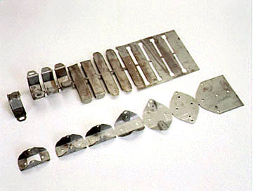 Metal hardware pieces: brackets, plates, and strips.