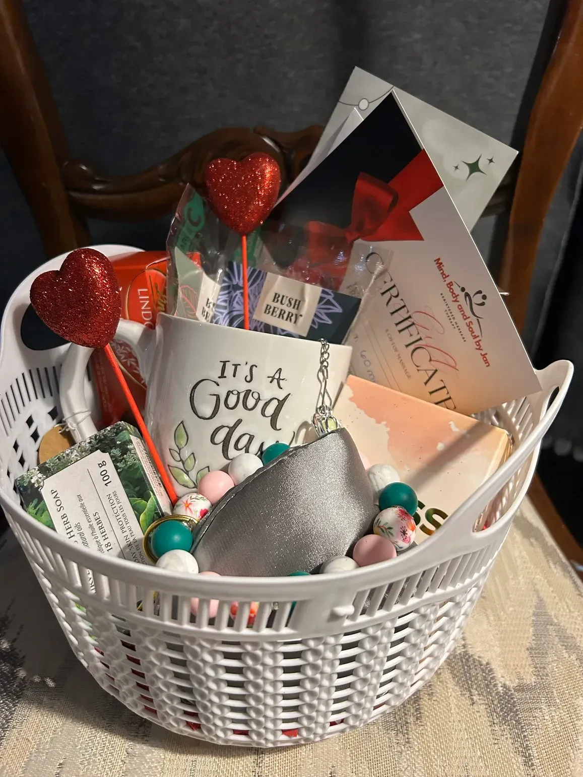 White basket of gift bags, cards, and heart toppers, with “It’s a Good Day” note visible.