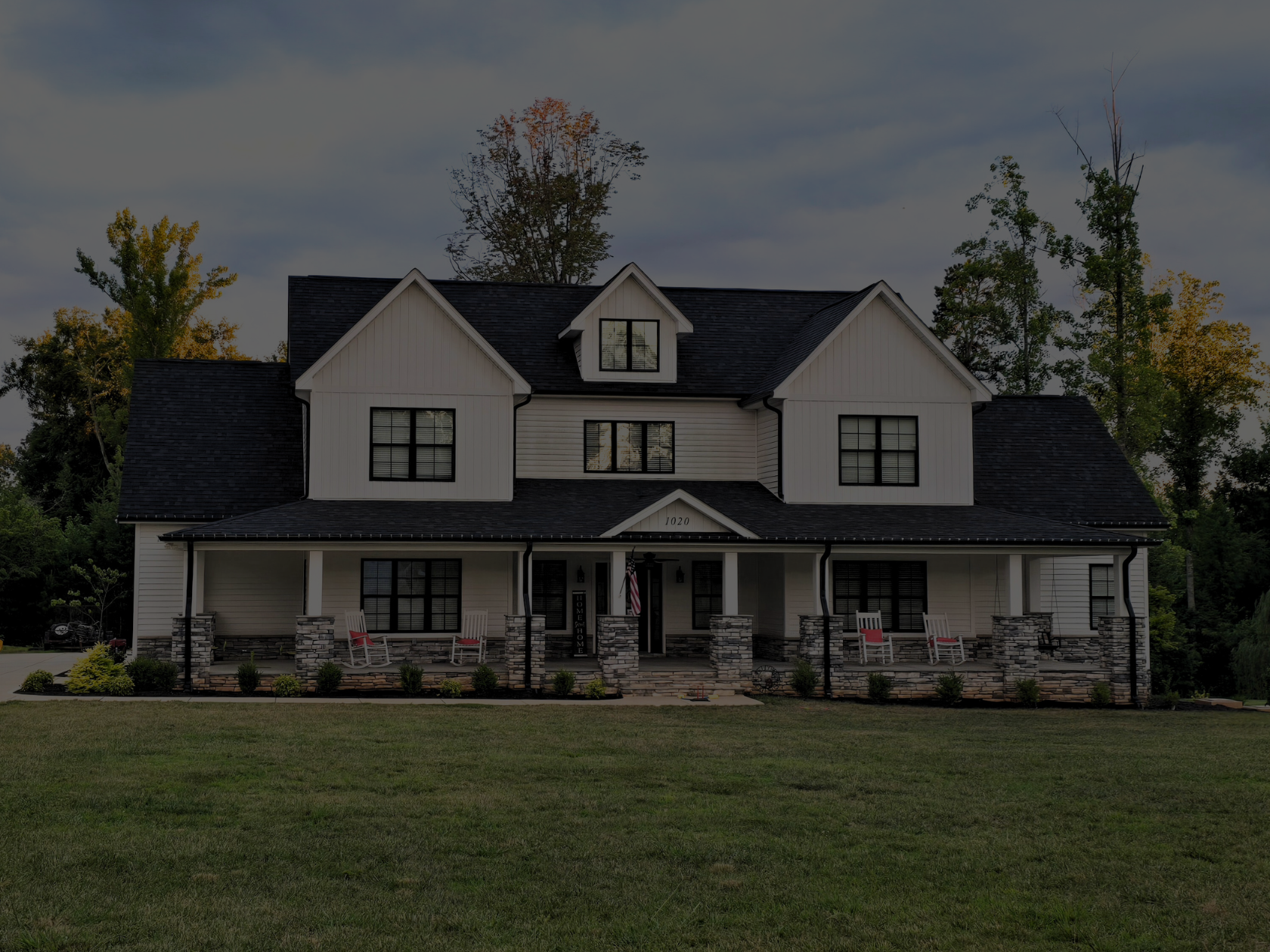 Large white house with trees and green grass
