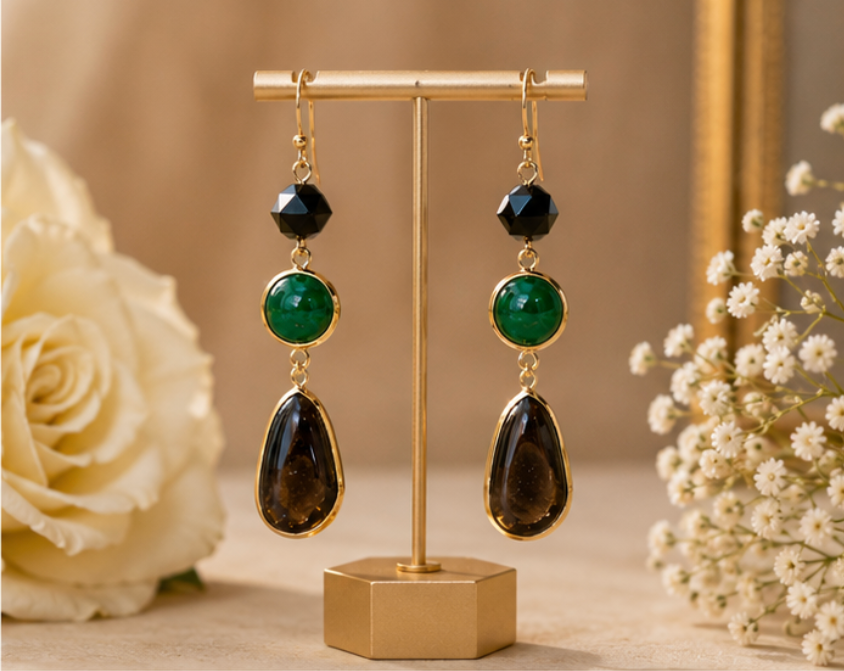 Pair of gold hoop earrings on a beige surface