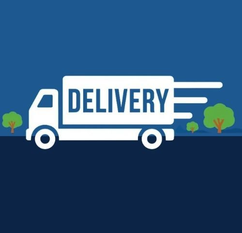 A delivery truck is driving down a road with trees in the background.