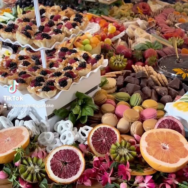 A table topped with a variety of fruits and desserts