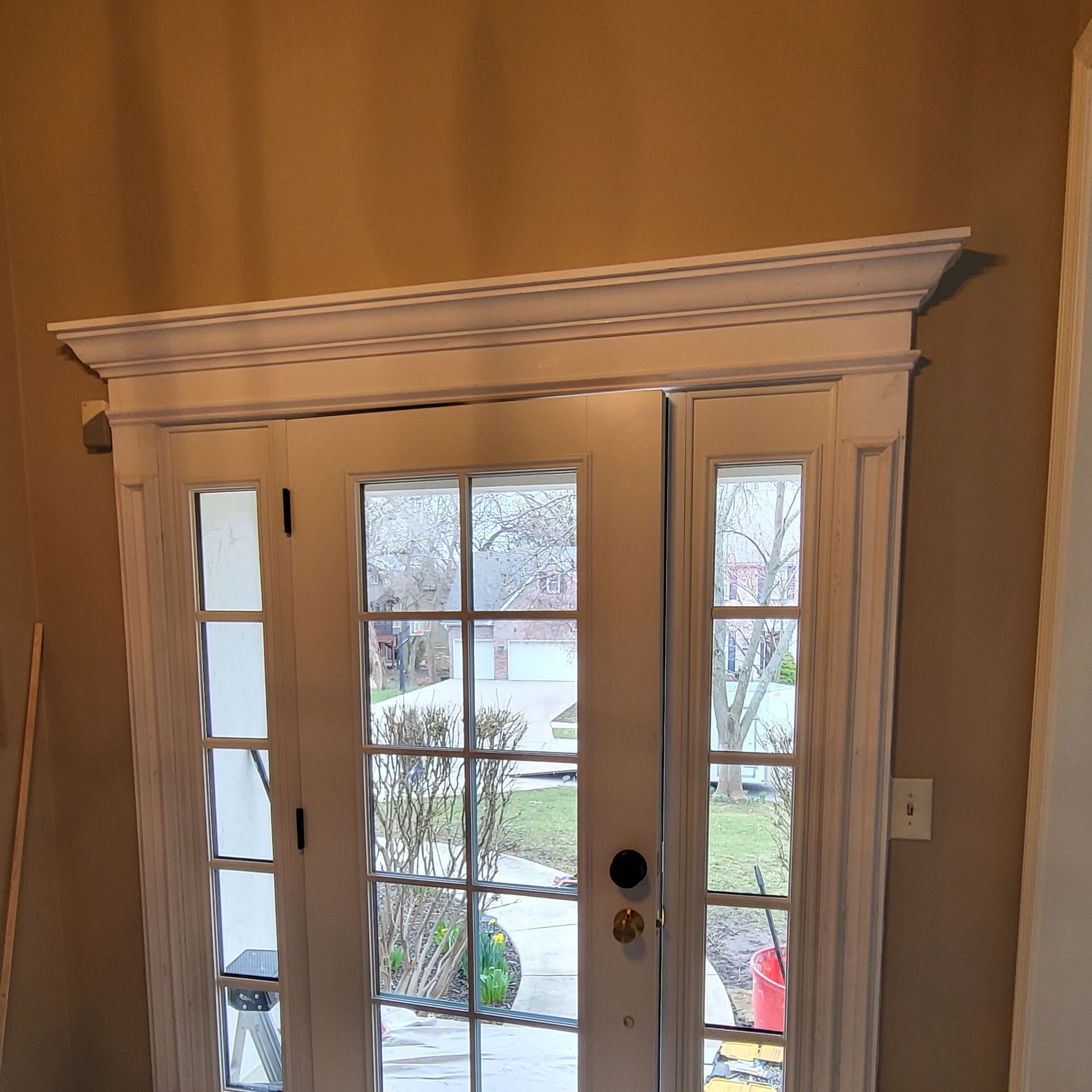 A white door with a window in a room