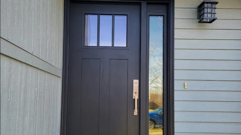 The front door of a house with a blue car parked in front of it.