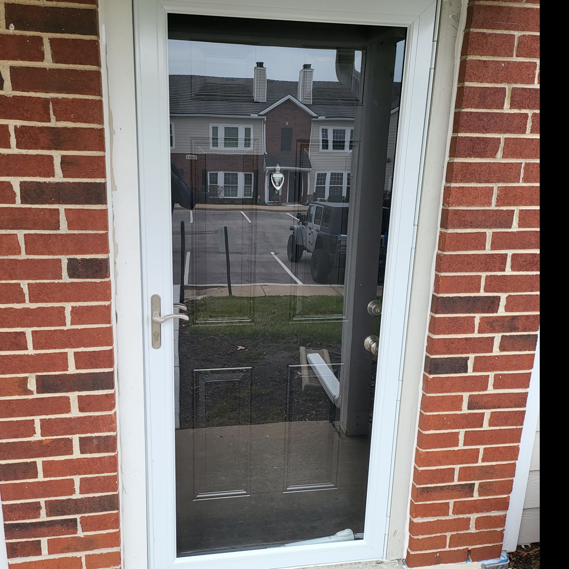 An empty room with a sliding glass door leading to a deck.