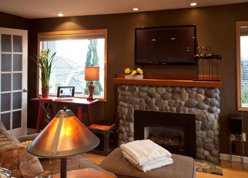 A living room with a fireplace and a flat screen tv
