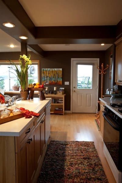 A kitchen with wooden cabinets and a white door