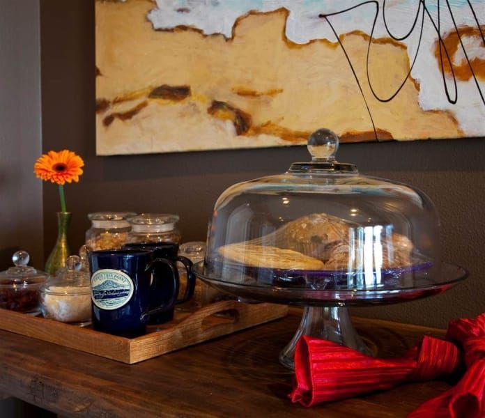 A table with a glass dome on top of a cake stand