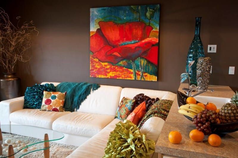 A living room with a couch and a painting on the wall