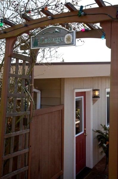 A house with a sign that says ' cottage ' on it