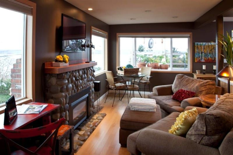 A living room with a fireplace and a flat screen tv