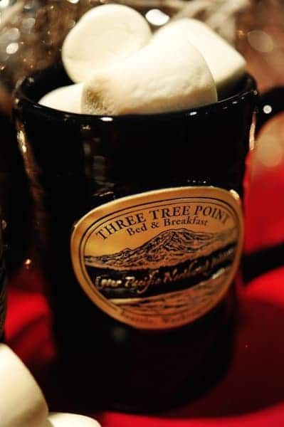 A black mug with a label that says three tree point