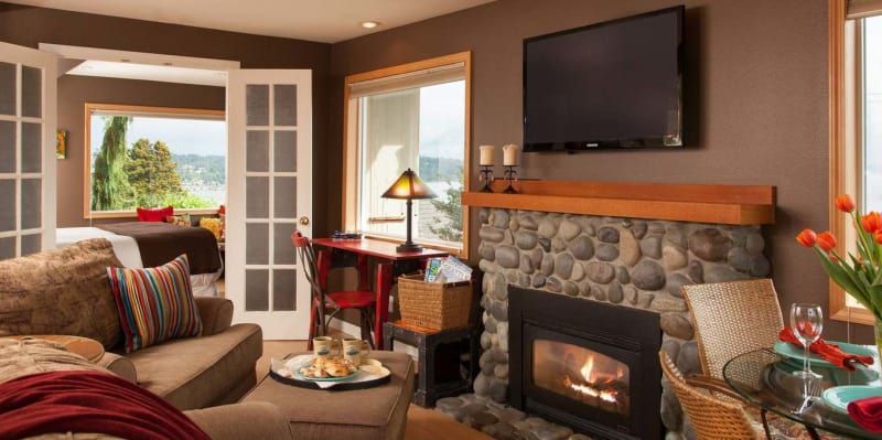 A living room with a fireplace and a flat screen tv.
