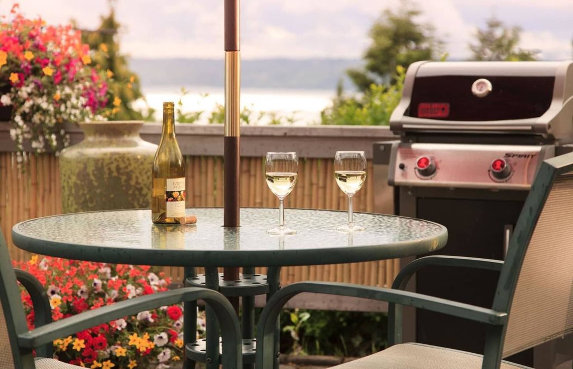 A table with two glasses of wine and a bottle of wine on it