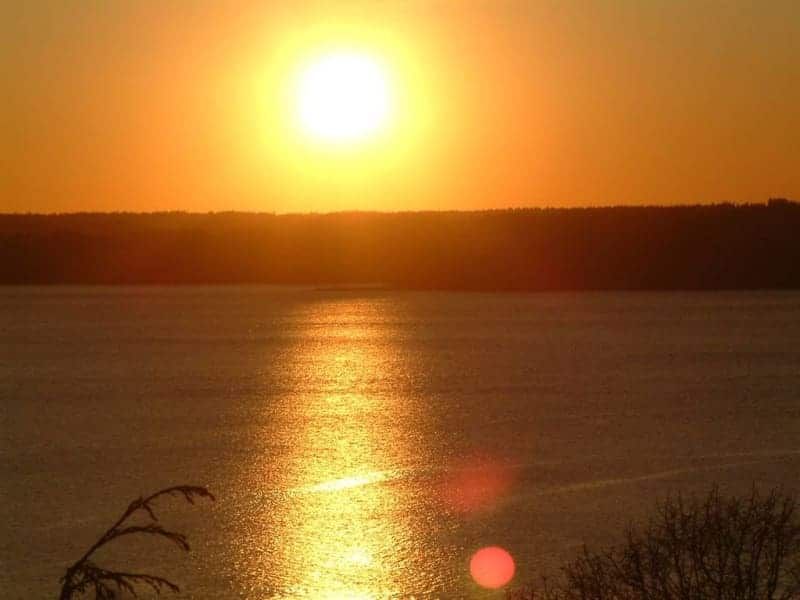 The sun is setting over a body of water.