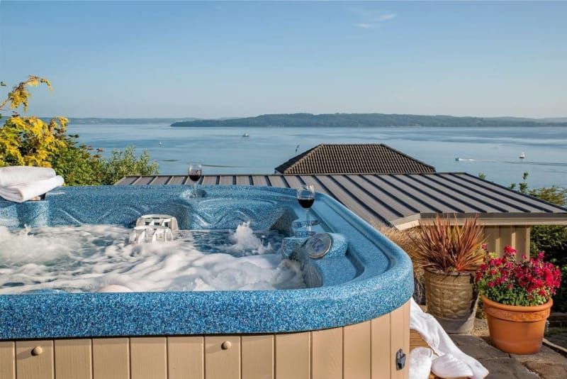 There is a hot tub with a view of the ocean.