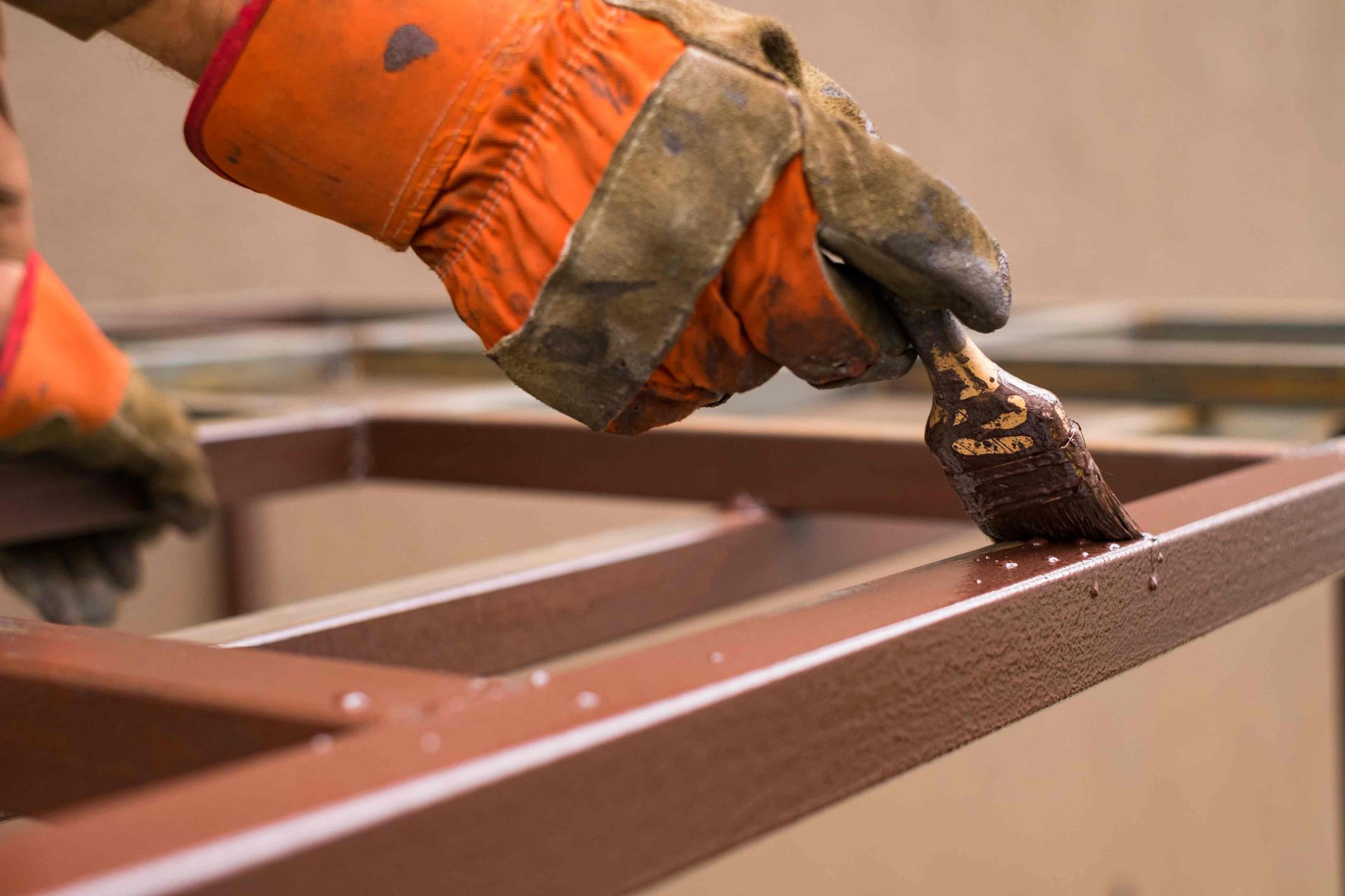A painter painting a metal surface with bronze paint near Fort Lauderdale, Florida (FL) 