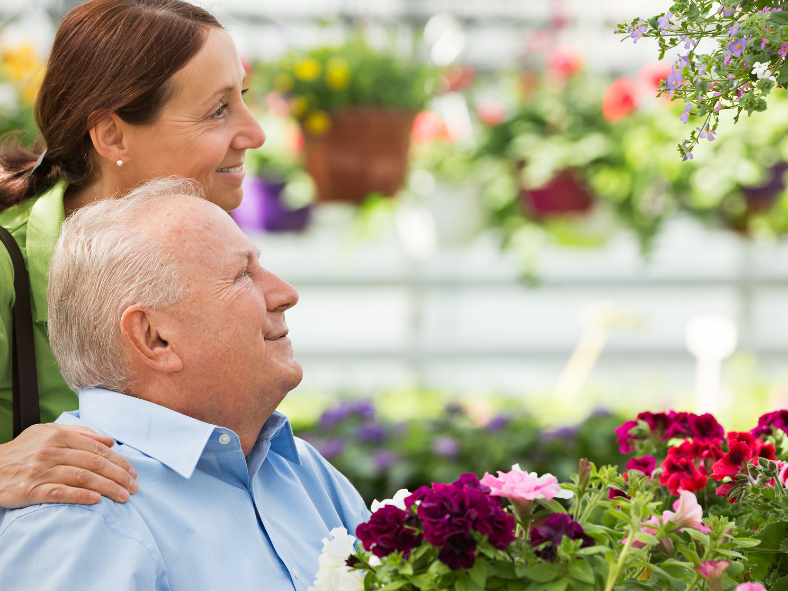 man and woman looking at flowers