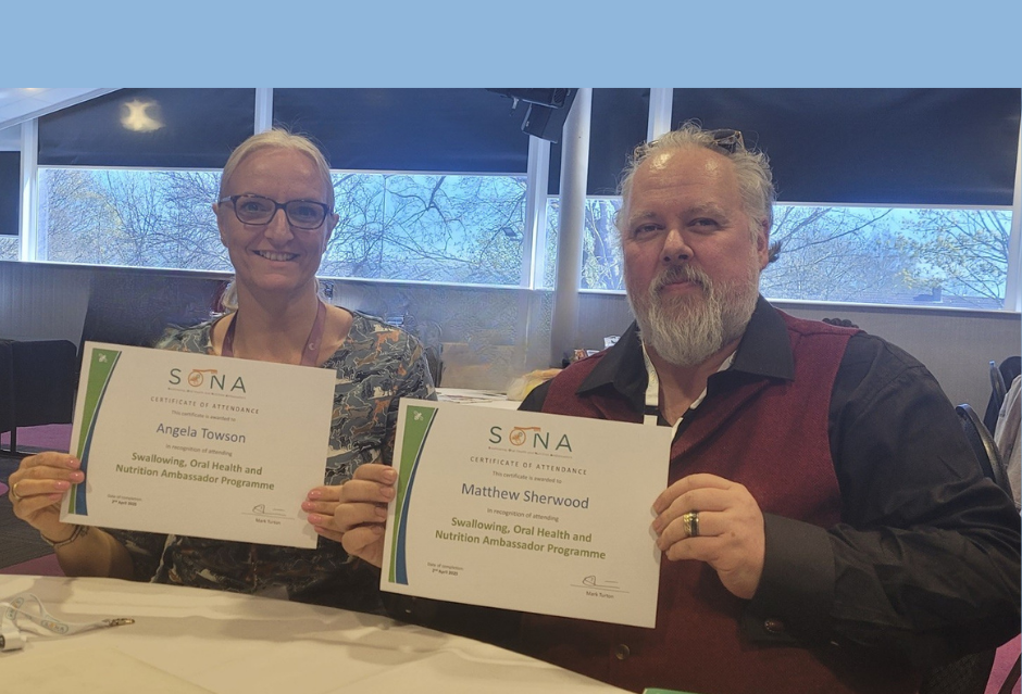 a woman and a man  holding certificates