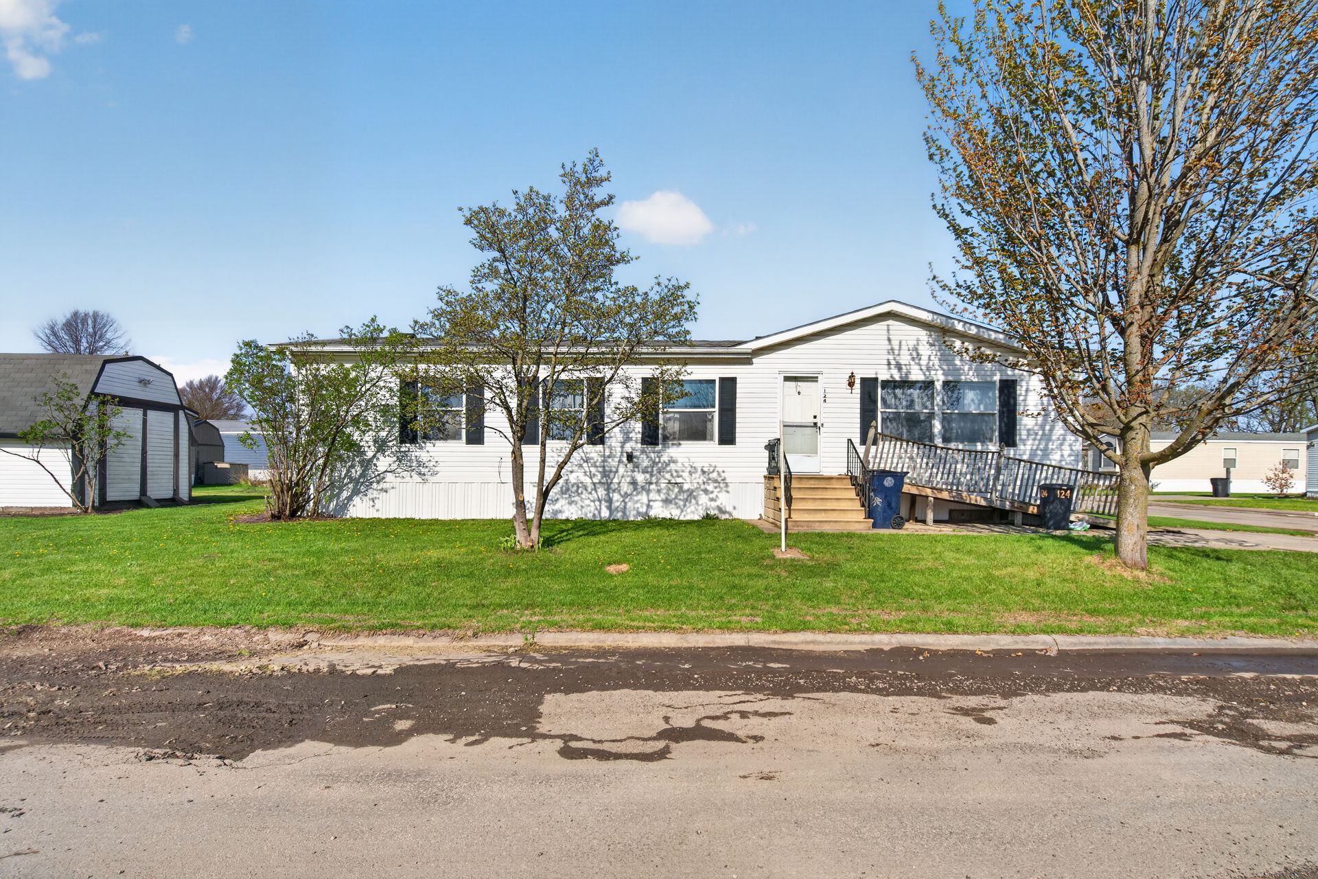 An aerial view of a mobile home park with lots of houses and trees.