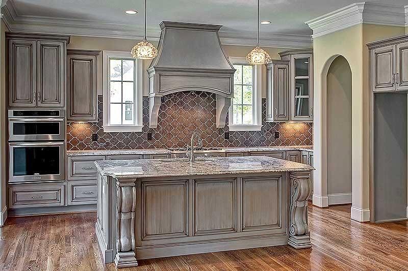 Spacious gray kitchen with center island, stainless appliances, and hardwood floors