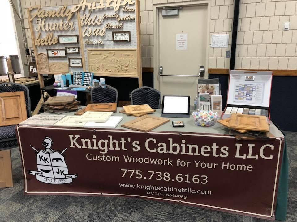 Knight’s Cabinets LLC booth with maroon tablecloth, sample boards, and woodwork display