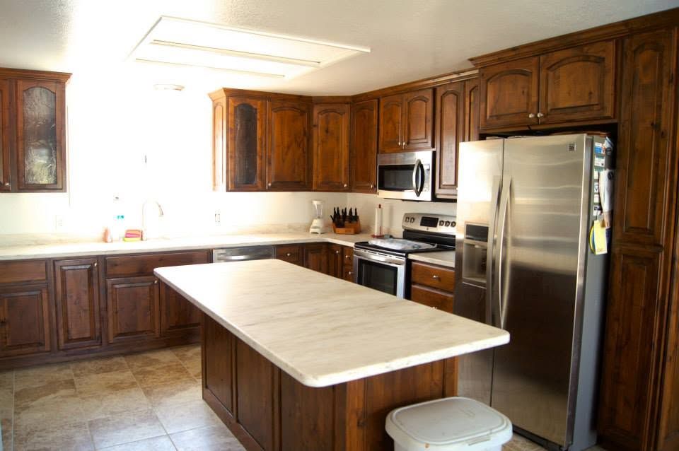 Bright kitchen with wooden cabinets, stainless steel appliances, and a central island countertop