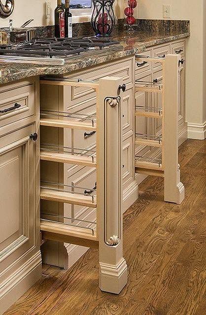 Kitchen cabinet with pull-out wire drawers beside a granite countertop and sink