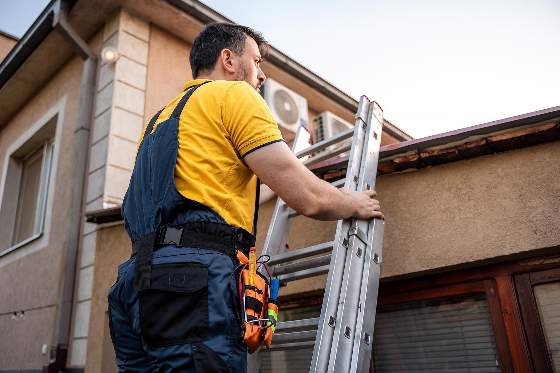 A man is inspecting a roof. A man is inspecting a roof.