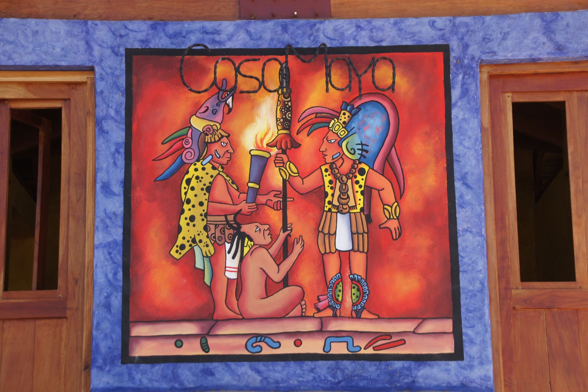 Colorful mural of three stylized figures on an orange background, framed by purple walls and wooden windows