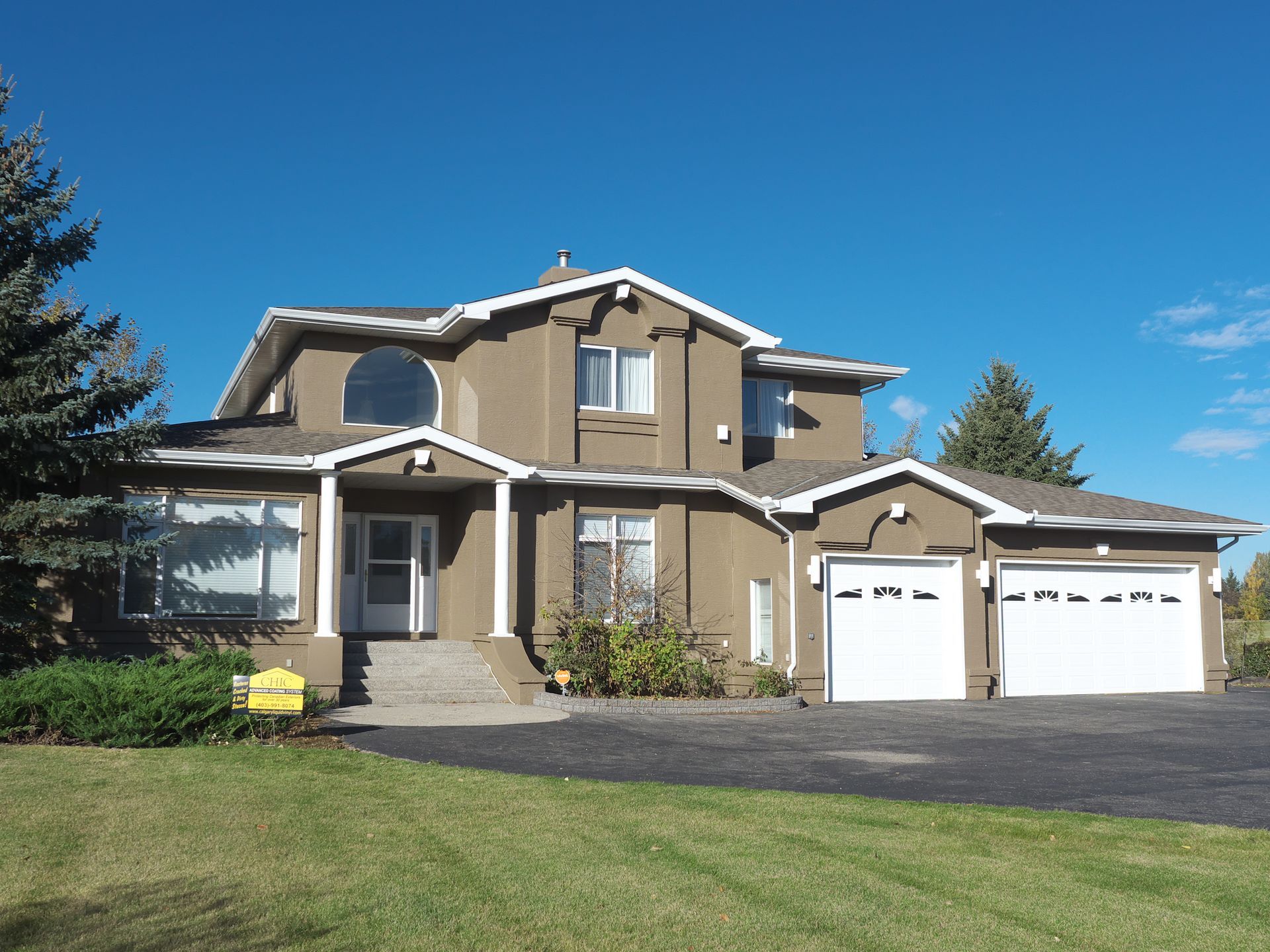 A large house with a for sale sign in front of it