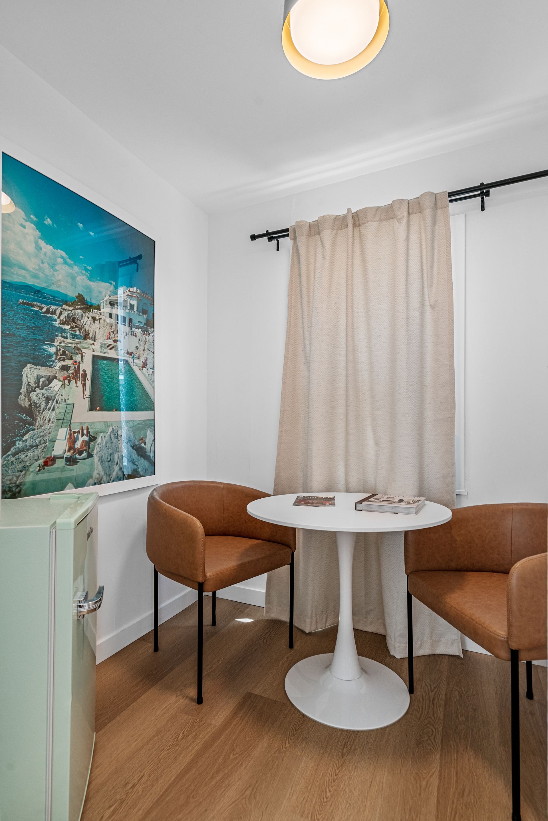 There is a table and two chairs in the room.