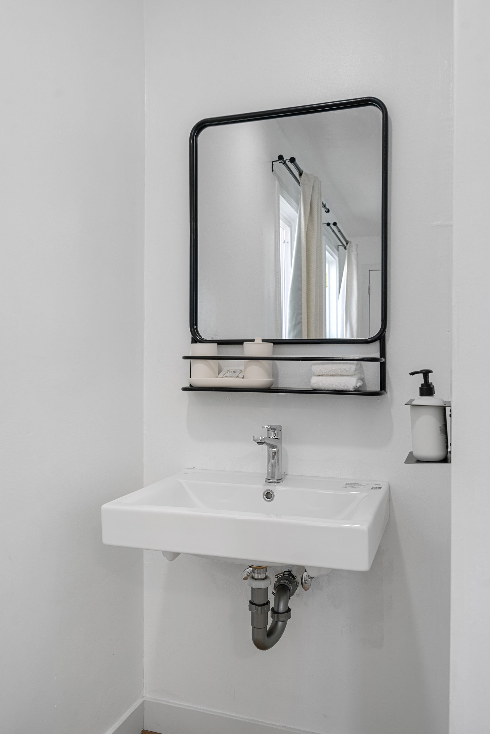 A bathroom sink with a mirror above it.