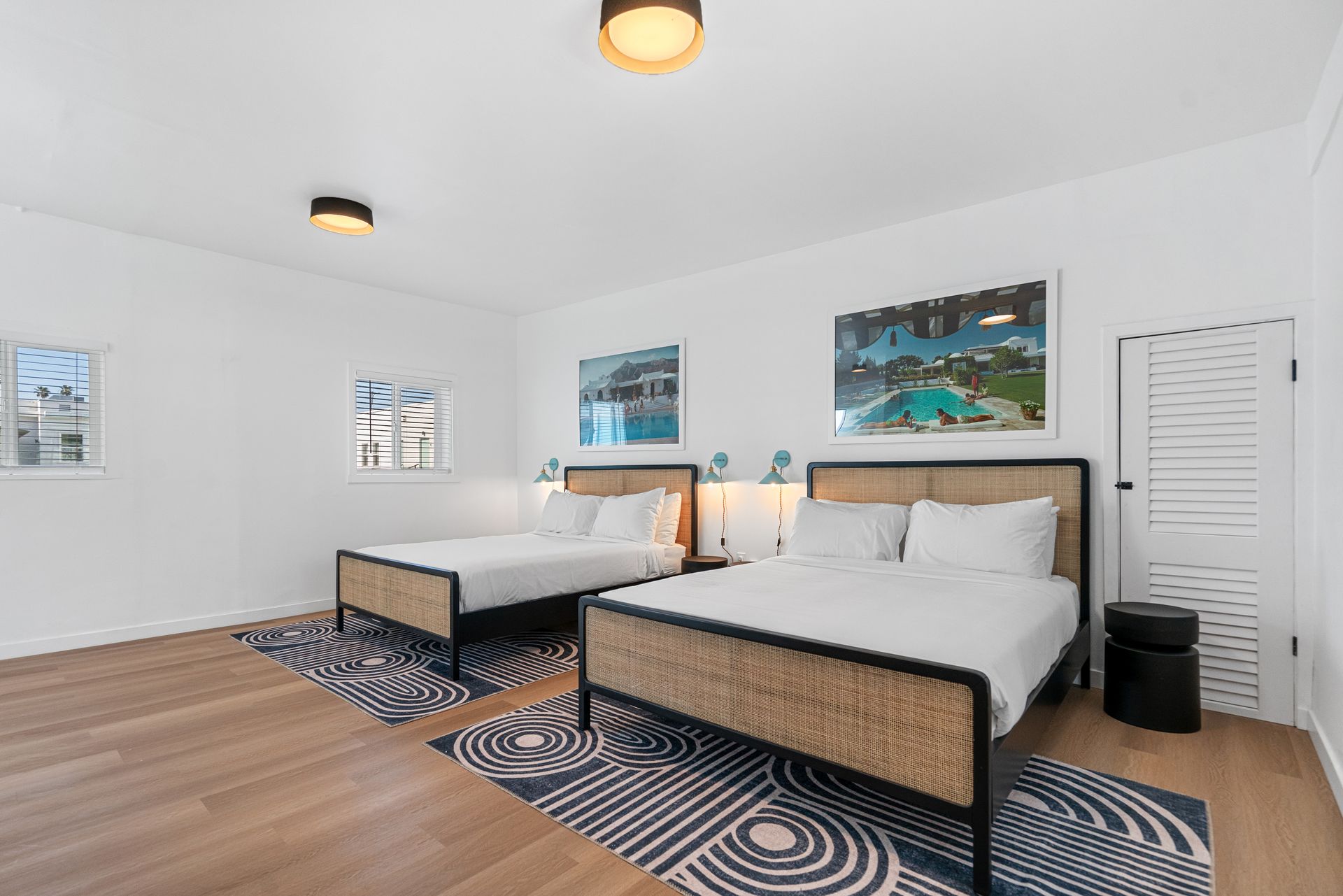 A hotel room with two beds and a rug.