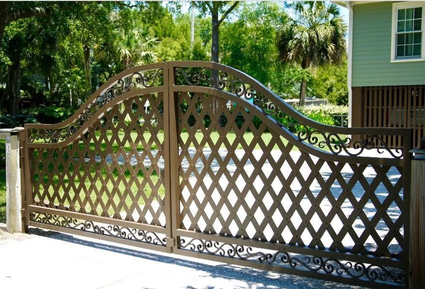Custom ornamental wrought iron fence and gate at a Charleston-style property