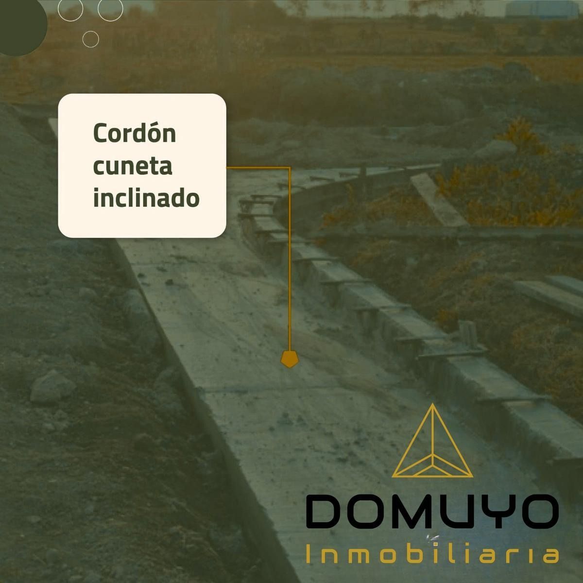 Vista aérea de una zona residencial verde con el texto “5.700m² de espacios verdes” y el logotipo de Domuyo Inmobiliaria.