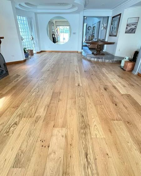 A Living Room With a Wooden Floor and a Mirror — Totally Flooring Gold Coast In Bundall, QLD
