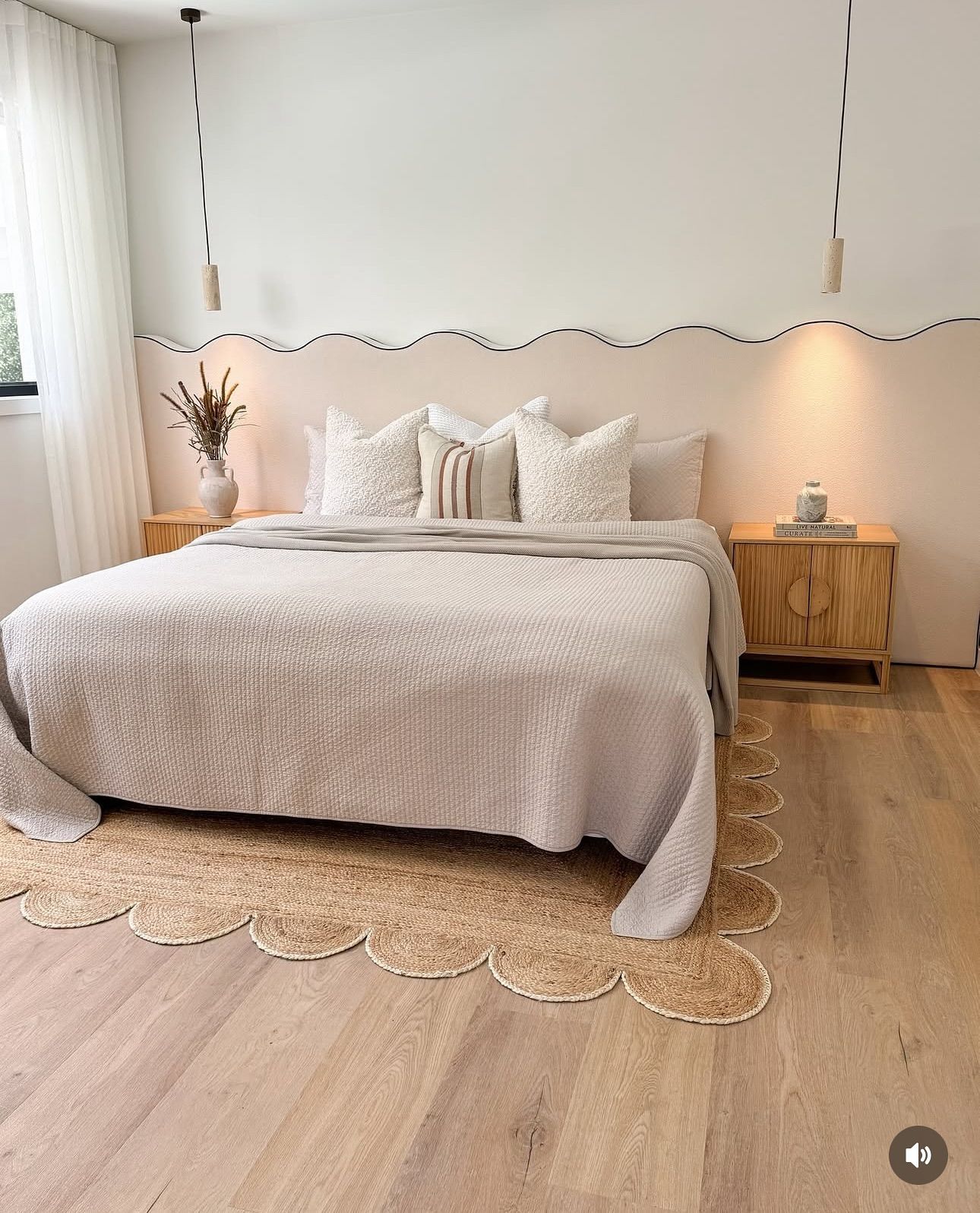 Bedroom with a beige bed, wooden nightstands, and a scalloped jute rug — Totally Flooring Gold Coast In Bundall, QLD
