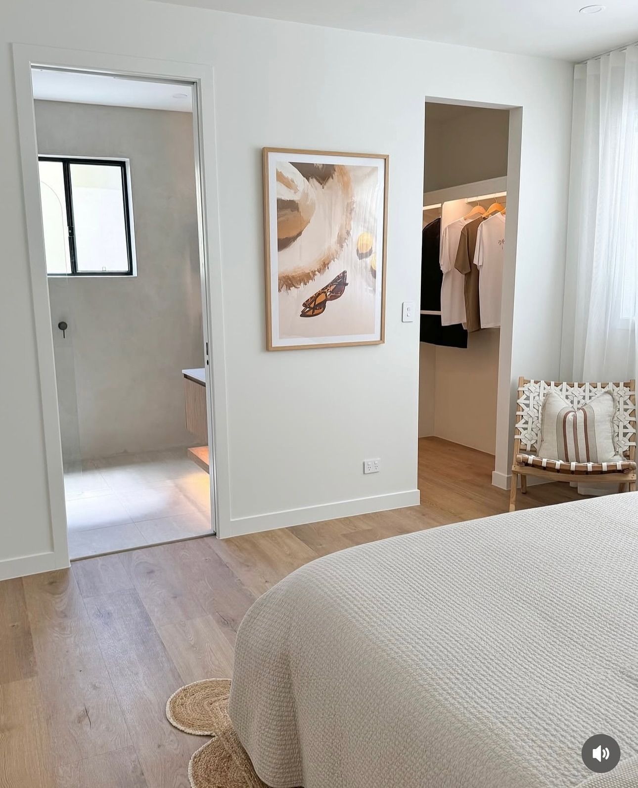 Bedroom with walk-in closet, bathroom, and neutral-toned art and decor — Totally Flooring Gold Coast In Bundall, QLD