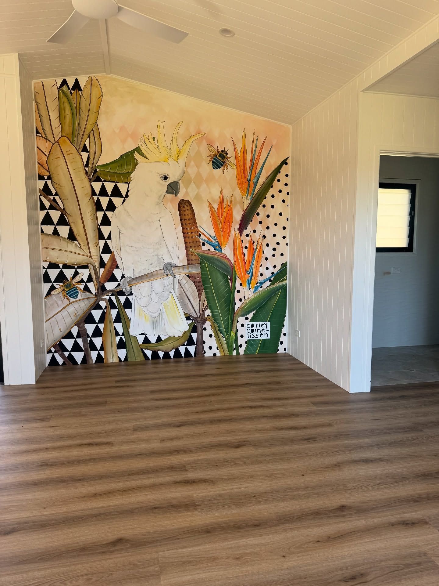 A room with a wall mural of a white cockatoo among plants — Totally Flooring Gold Coast In Bundall, QLD