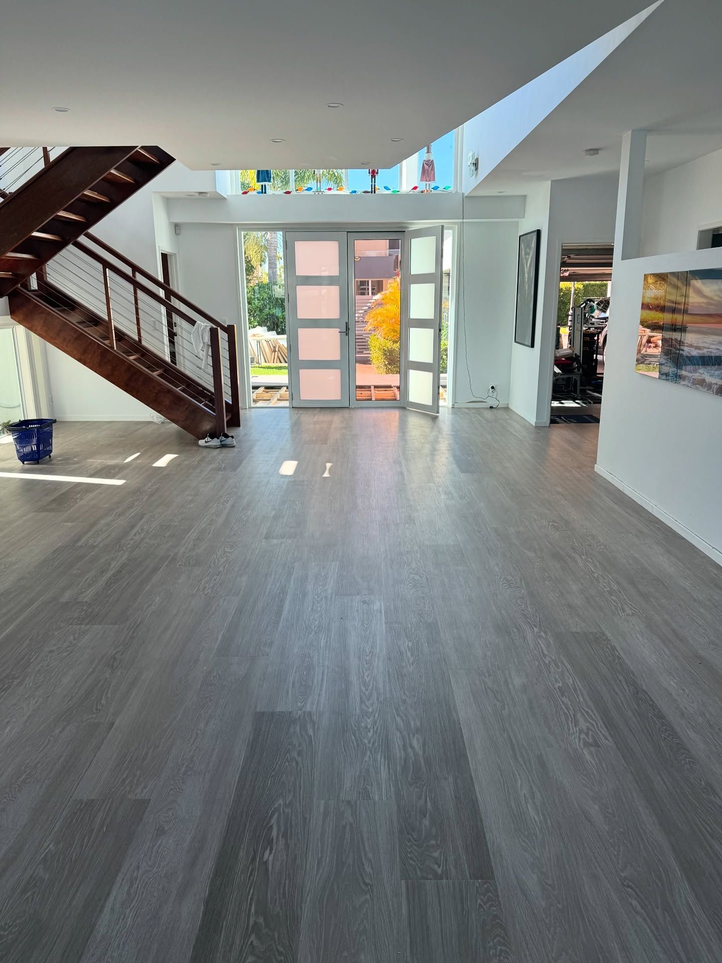 Spacious interior with gray wood-look flooring — Totally Flooring Gold Coast In Bundall, QLD