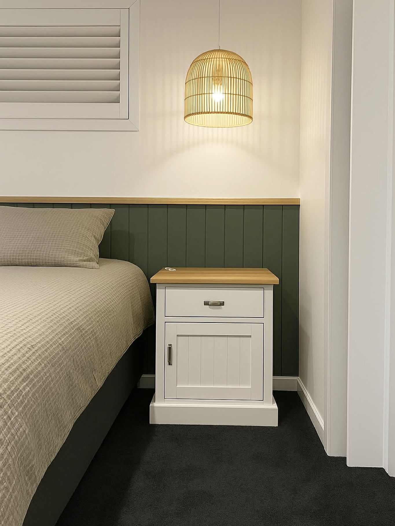 Bedroom scene: bed with beige comforter, white nightstand with wood top — Totally Flooring Gold Coast In Bundall, QLD